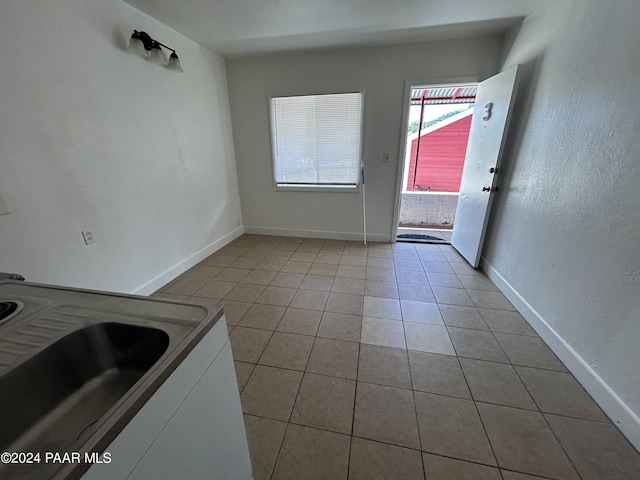 interior space featuring white cabinetry and light tile patterned floors