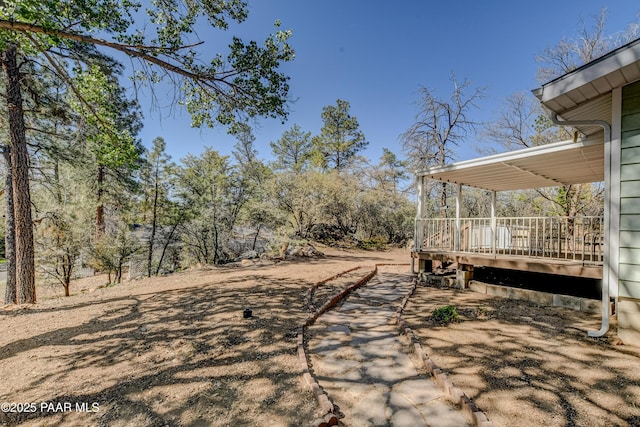 view of yard featuring a wooden deck