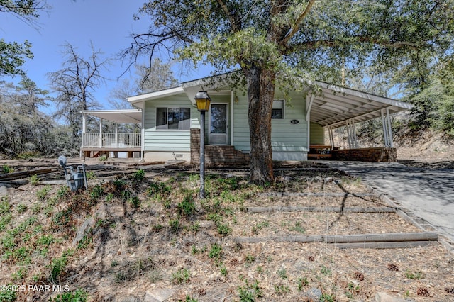 view of front of property with a carport and concrete driveway
