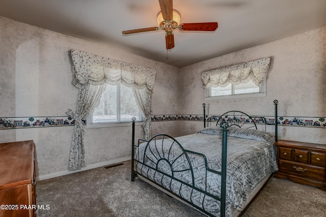bedroom with carpet, visible vents, ceiling fan, and multiple windows
