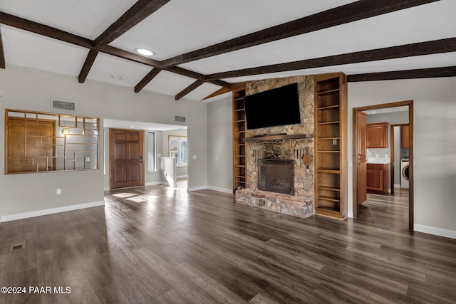 unfurnished living room with built in features, a fireplace, lofted ceiling with beams, dark hardwood / wood-style flooring, and washer / dryer