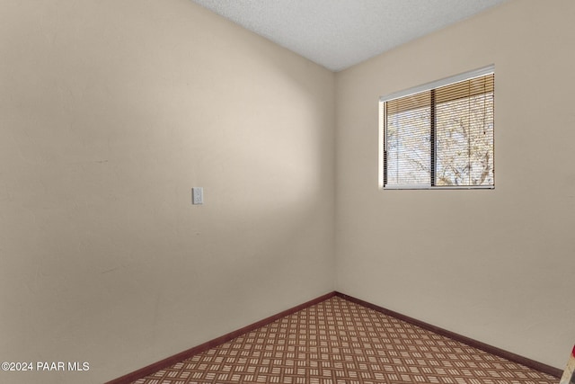 empty room featuring a textured ceiling