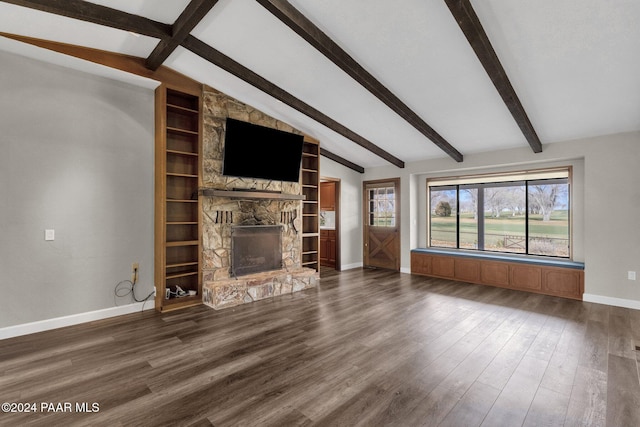 unfurnished living room featuring a stone fireplace, dark hardwood / wood-style floors, vaulted ceiling with beams, and built in features