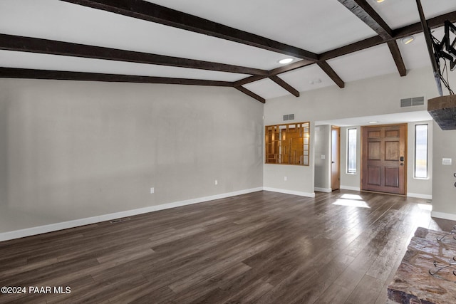 unfurnished living room featuring dark hardwood / wood-style flooring and vaulted ceiling with beams