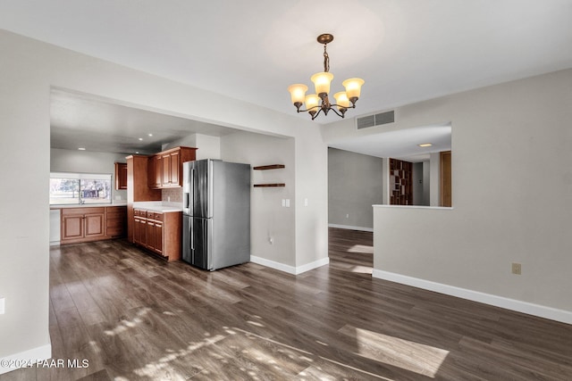 kitchen featuring stainless steel refrigerator with ice dispenser, dark wood-type flooring, a notable chandelier, and decorative light fixtures