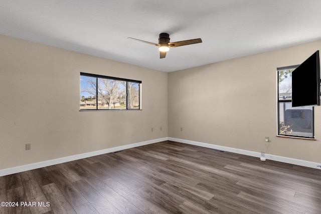 empty room with dark hardwood / wood-style floors and ceiling fan