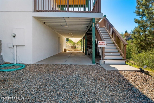 exterior space with stucco siding and stairs