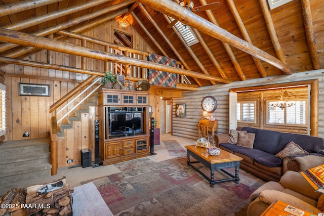 living room featuring wooden walls, wooden ceiling, a notable chandelier, high vaulted ceiling, and rustic walls