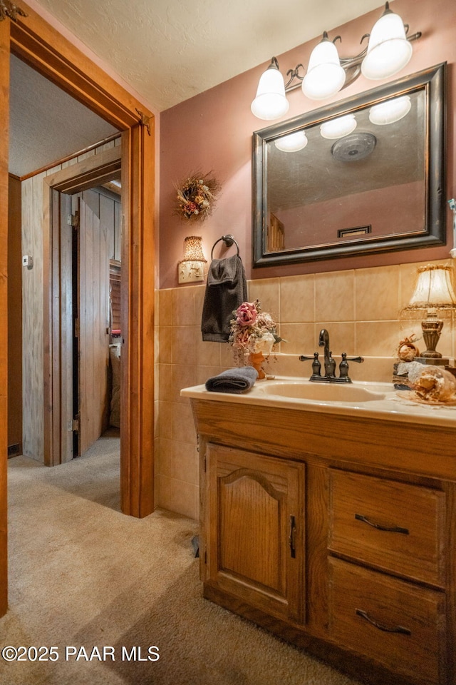 bathroom with decorative backsplash and vanity