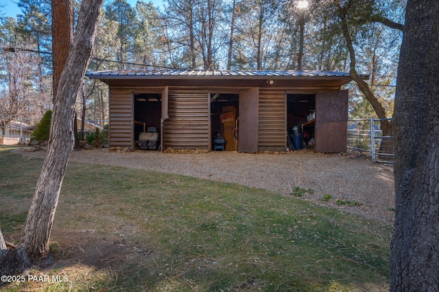 view of outbuilding featuring a yard