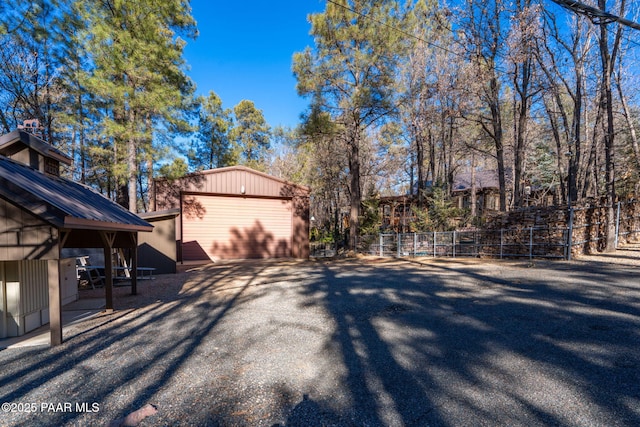 view of side of home featuring a garage and an outdoor structure