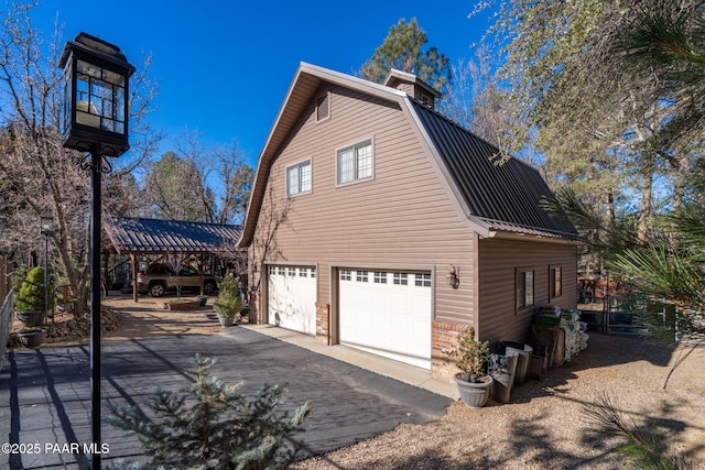 view of side of home featuring a carport and a garage