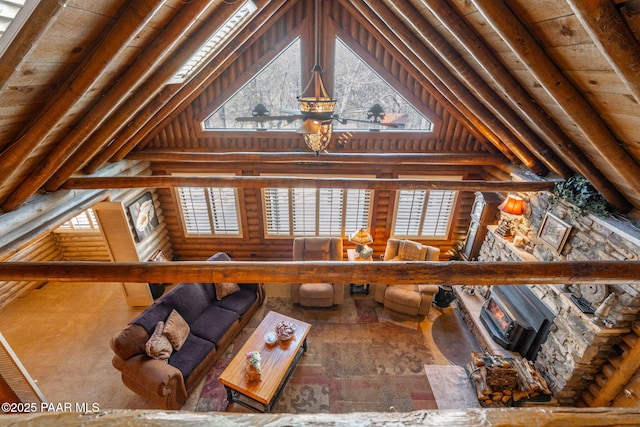 unfurnished living room with high vaulted ceiling, rustic walls, and wooden ceiling