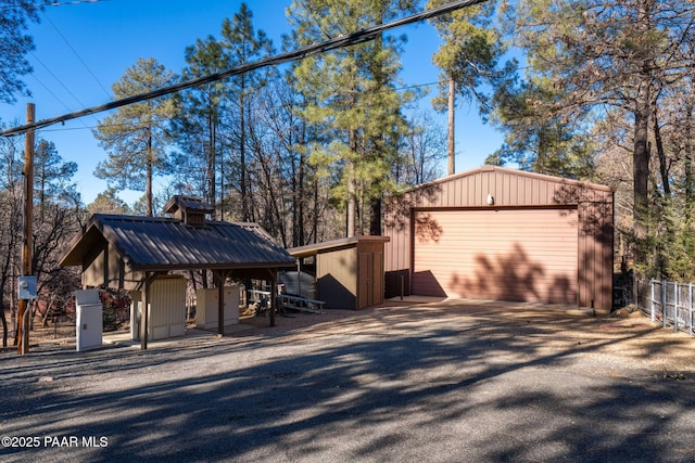 view of side of property featuring a garage and an outbuilding