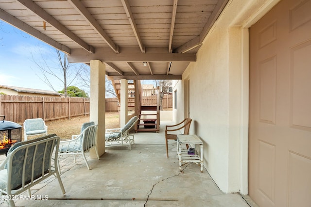 view of patio with a fenced backyard and stairs