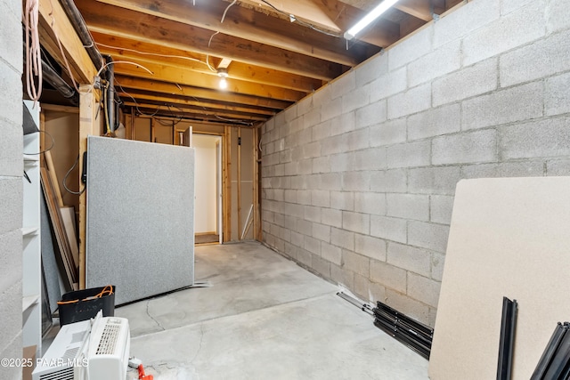 unfinished basement featuring refrigerator