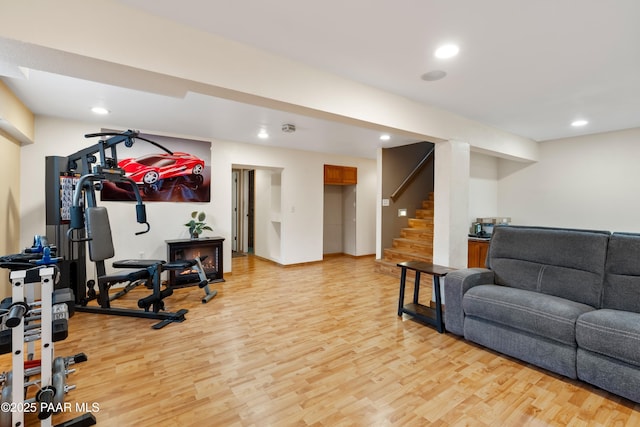 workout room with light wood-type flooring and recessed lighting