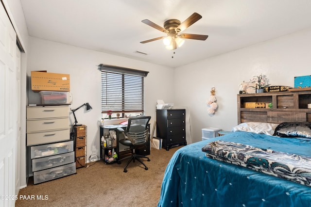 bedroom featuring a ceiling fan, a closet, visible vents, and carpet flooring