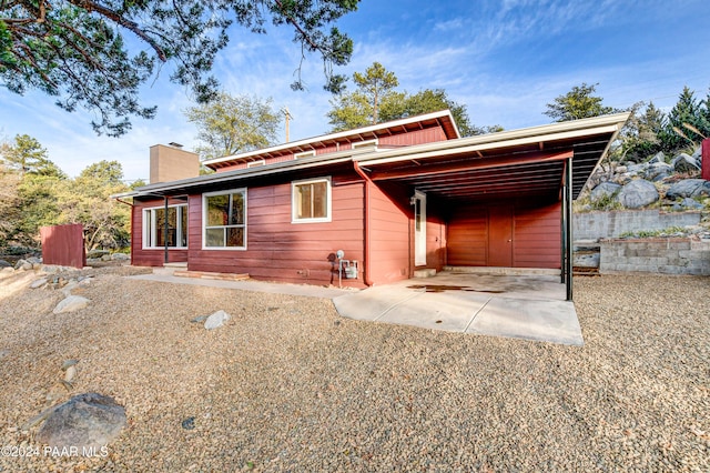 rear view of house with a carport