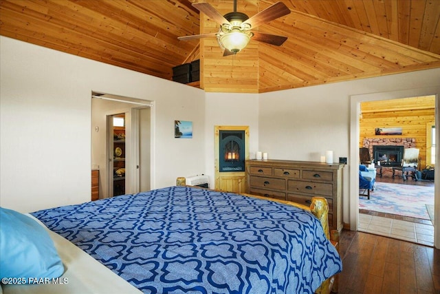 bedroom with dark hardwood / wood-style flooring, high vaulted ceiling, ceiling fan, and wood ceiling