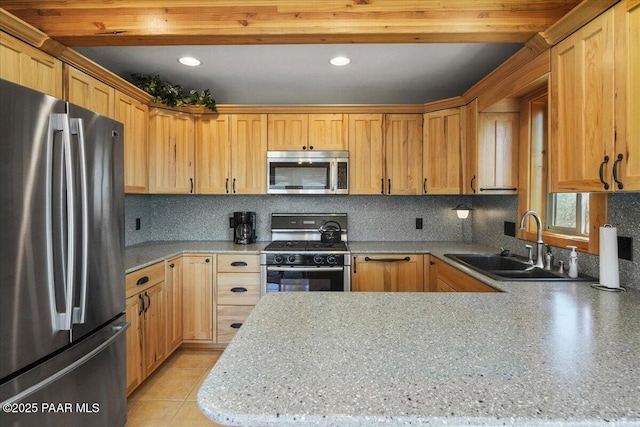 kitchen with sink, tasteful backsplash, and appliances with stainless steel finishes