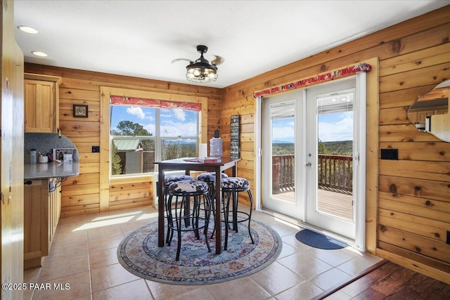 tiled dining room with wood walls