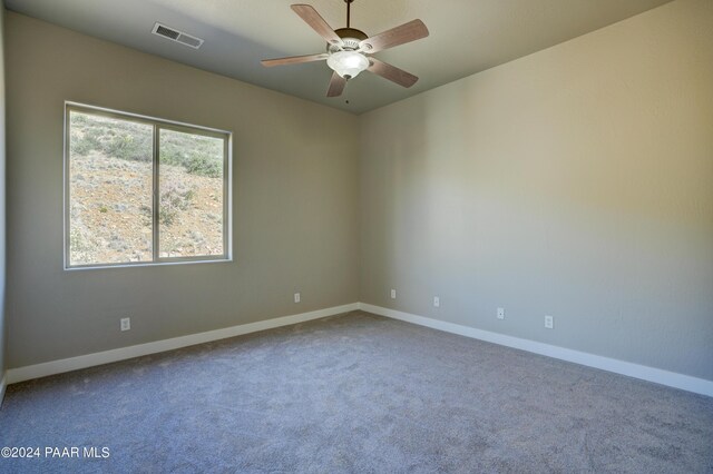 carpeted empty room with ceiling fan