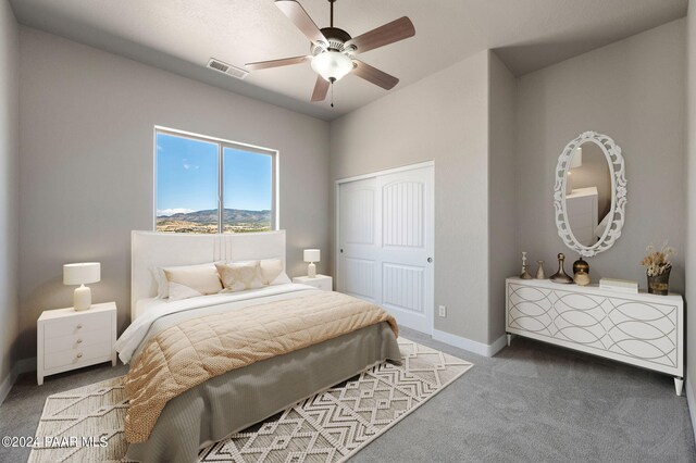 carpeted bedroom with a closet and ceiling fan