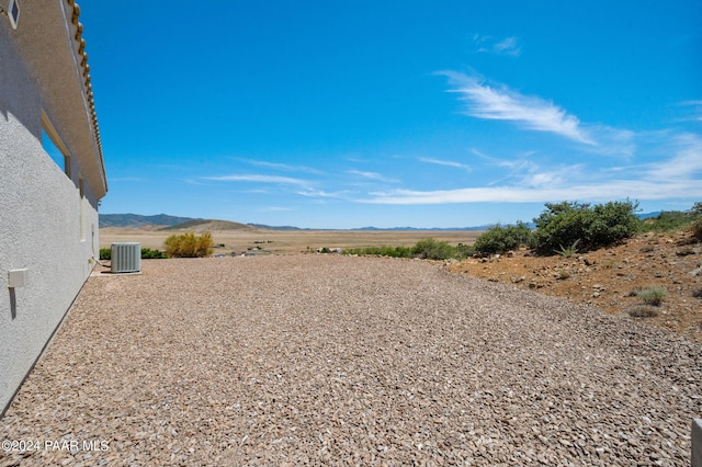 view of yard with a mountain view and central air condition unit