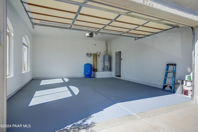 garage with a garage door opener and water heater