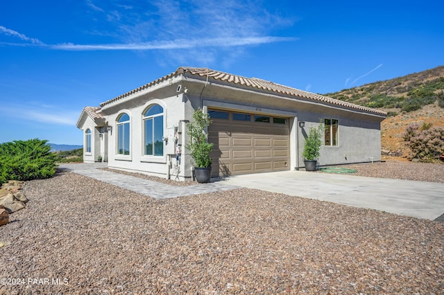 mediterranean / spanish-style home featuring a garage