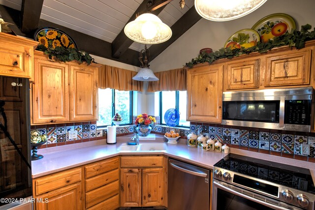 kitchen with lofted ceiling with beams, sink, tasteful backsplash, decorative light fixtures, and stainless steel appliances