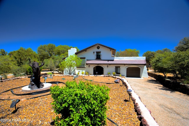 mediterranean / spanish-style home featuring a garage