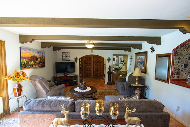 living room featuring beamed ceiling and light tile patterned flooring