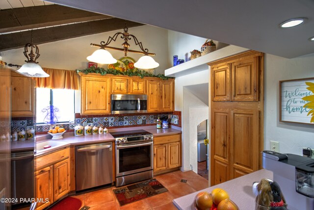 kitchen with stainless steel appliances, vaulted ceiling with beams, decorative light fixtures, decorative backsplash, and light tile patterned flooring