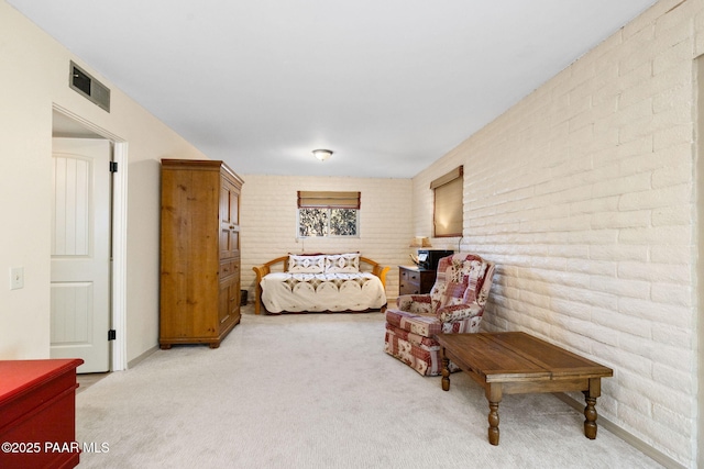 bedroom featuring brick wall and carpet flooring