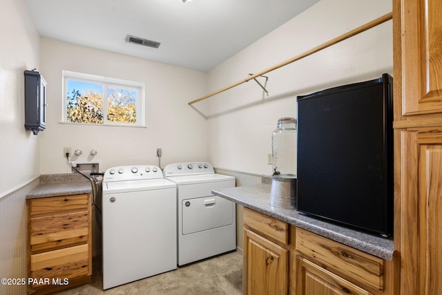 laundry area featuring cabinets and washer and dryer