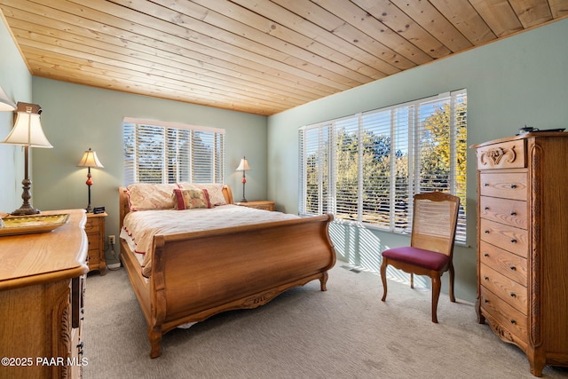 bedroom with multiple windows, light carpet, and wooden ceiling