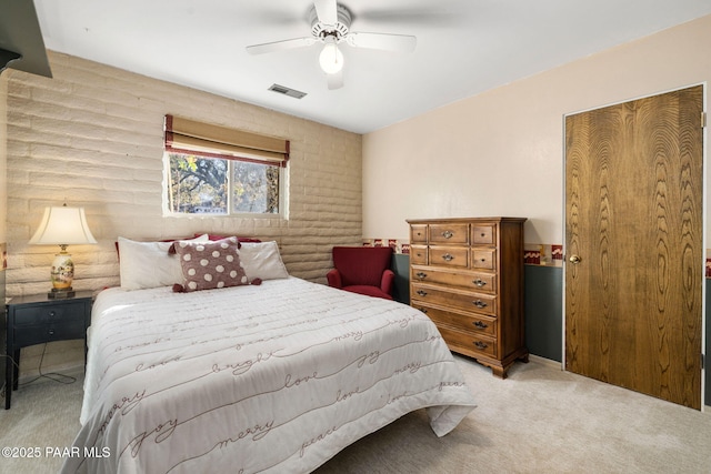 bedroom with light carpet, log walls, and ceiling fan