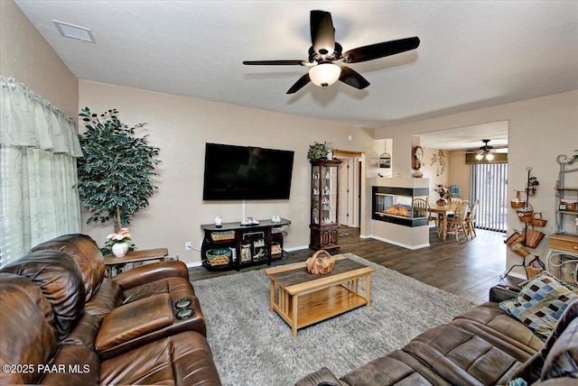 4761 N Tonto Way, Prescott Valley, AZ 86314 - living room with a ceiling fan, wood finished floors, and a multi sided fireplace