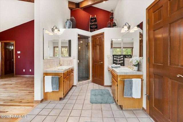 bathroom featuring tile patterned flooring, a healthy amount of sunlight, and a sink