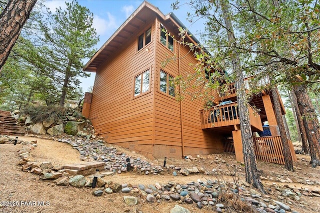 view of side of home featuring a wooden deck