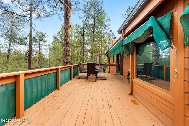 wooden deck featuring outdoor dining area