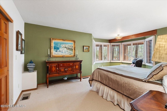 carpeted bedroom with baseboards and visible vents