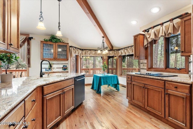 kitchen featuring light stone countertops, pendant lighting, stainless steel dishwasher, brown cabinetry, and a sink