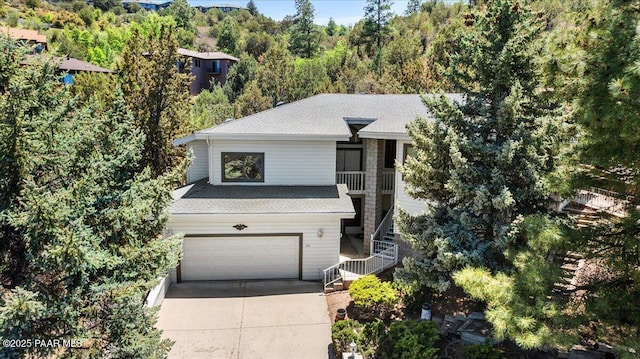 110 High Chaparral Loop, Prescott, AZ 86303 - view of front of house featuring stairway, an attached garage, concrete driveway, and a shingled roof