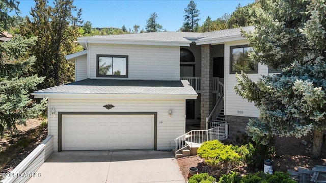 110 High Chaparral Loop, Prescott, AZ 86303 - view of front of property with stairway, roof with shingles, concrete driveway, and a garage