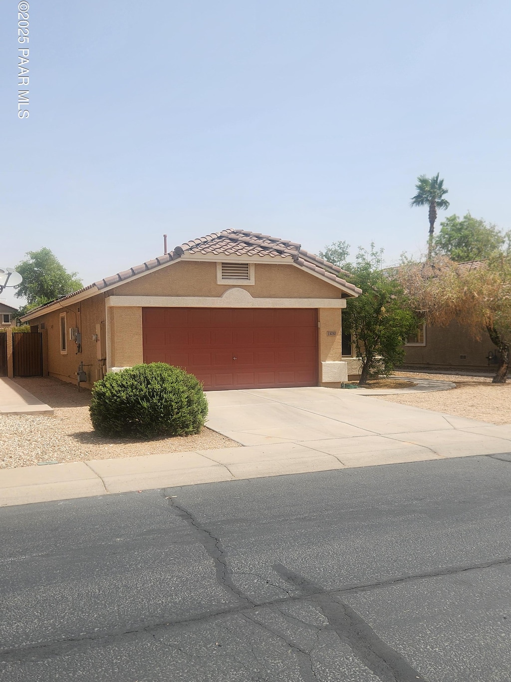 13030 W Columbine Dr, El Mirage, AZ 85335 - view of front facade with driveway, a garage, stucco siding, and a tile roof