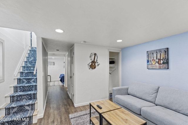 living room featuring stairway, recessed lighting, baseboards, and wood finished floors