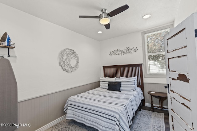 bedroom with ceiling fan and hardwood / wood-style flooring